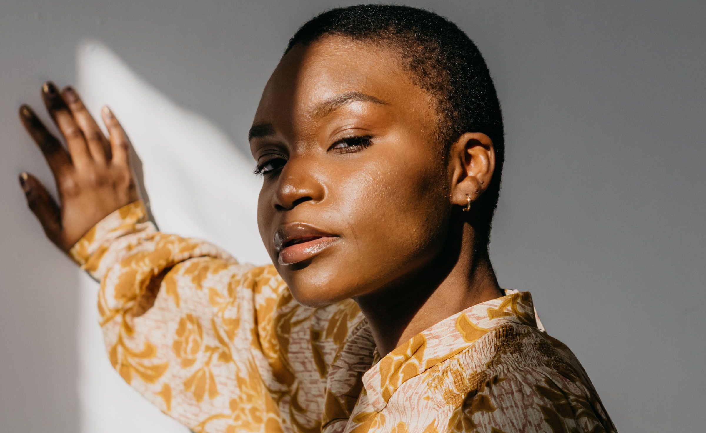A confident woman in a floral blouse